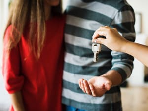 A couple getting the keys to a house that they just bought without an agent on Next Address